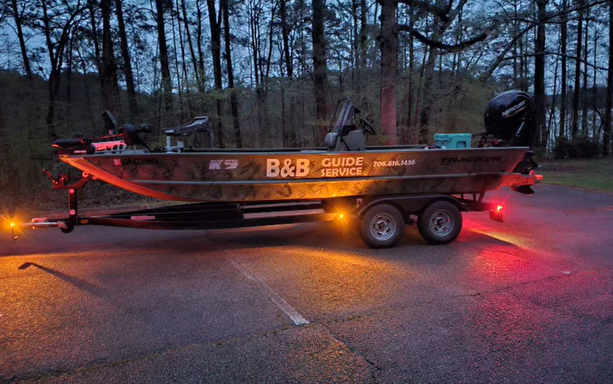 Boat on trailer with words B&B Guide Service on the side