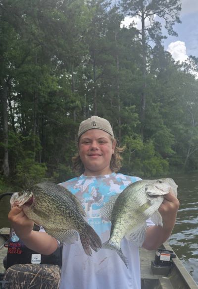 Young boy holding two fish he caught